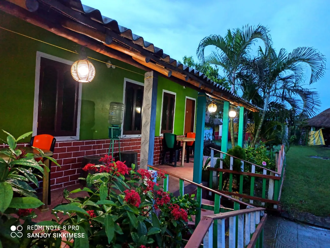Tajpur Retreat cottage at dusk with lanterns glowing