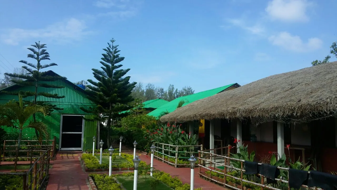 Resort gardens with lamp posts and thatched buildings